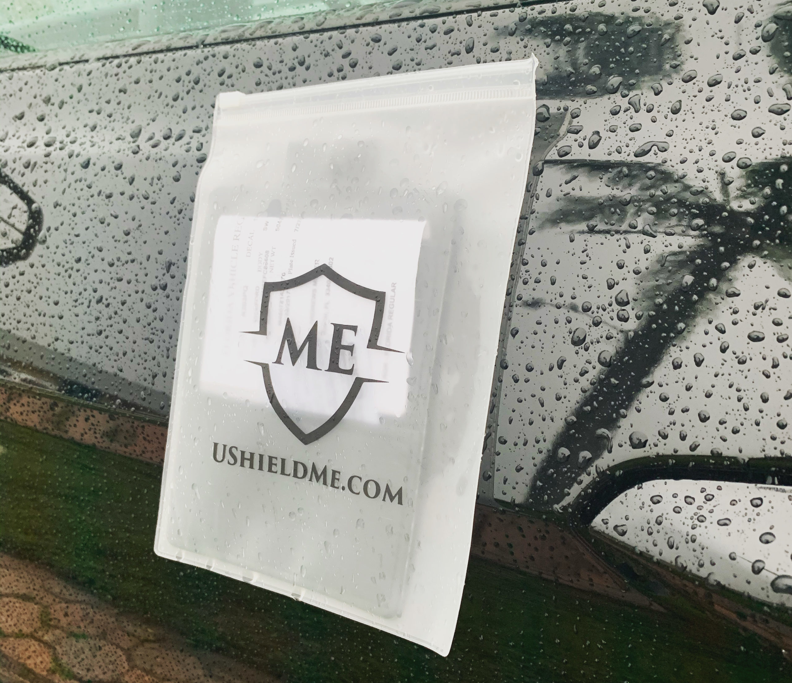 The Shield rain cover protecting documents on a wet vehicle window